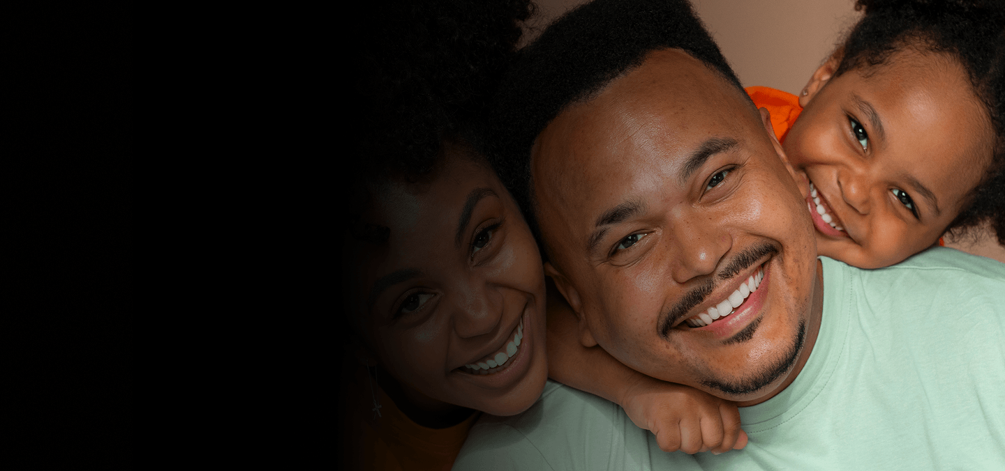 Smiling family embracing
